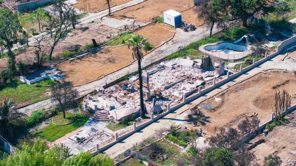 pexels-photo-32026178-32026178 Aerial shot showing a destroyed house by wildfire in Altadena, California, highlighting the devastation.
